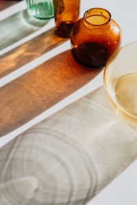 Kaboompics - Close-Up of Textured Amber Glassware and Its Warm Shadow