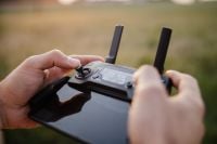 Kaboompics - Man holding remote controller for drones flying
