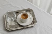 Kaboompics - Coffee Cup and Water Glass on Silver Tray and White Bedding