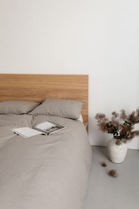 Kaboompics - Open Book and Dried Flowers Beside a Bed