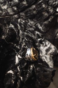 Kaboompics - Close-Up Gold Ring on a Black Textured Surface