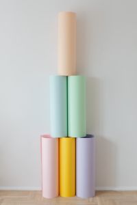 Kaboompics - Pastel Paper Rolls Stacked in a Vertical Arrangement