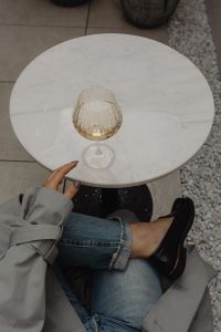 Kaboompics - Wine Glass on Round Marble Table With Copy Space