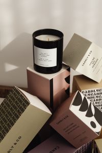 Kaboompics - Black Scented Candle Jar Beside Neutral Gift Boxes