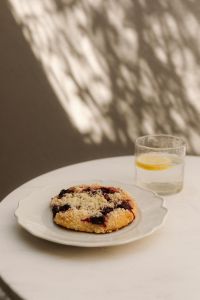 Kaboompics - Cherry Pastry on a Scalloped Plate with Lemon Water