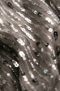 Kaboompics - Silver Sequin Fabric with Diagonal Folds