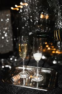 Kaboompics - Pouring Champagne Into Two Glasses At A New Year's Eve Party
