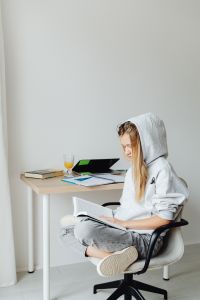 Kaboompics - Student Reading Book at Home Study Desk