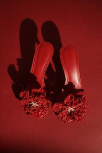 Kaboompics - Red Flower Sandals on a Deep Red Background with Copy Space, Fashion Flat Lay