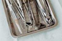 Kaboompics - Dental Forceps and Hand Instruments Arranged in a Metal Tray