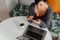 Kaboompics - A brunette woman works with a laptop and a phone