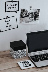Minimalist Graphic Design Workspace with Motivational Quote Cards and Black-and-White Street Photography