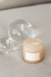 Kaboompics - Blank Candle Label Mockup with Glass Orbs on Beige Fabric