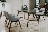 Kaboompics - Glass Dining Table with Upholstered Chairs and Neutral Patterned Rug