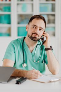 Kaboompics - Doctor Speaking on Smartphone at Medical Desk