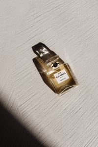 Kaboompics - Chanel No. 5 Perfume Bottle on Textured White Wall