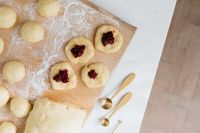 Kaboompics - Jam-Filled Pączki Dough and Gold Spoons on a White Counter