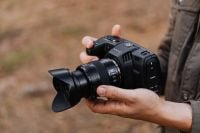 Kaboompics - Person Carrying Cinema Camera with Shoulder Strap in Nature