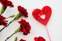 Kaboompics - Red Heart Lollipop With Carnations on White Background