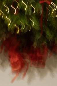 Kaboompics - Blurred Red Christmas Presents beneath Tree with Warm Light Trails