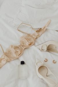 Kaboompics - Beige Satin Bra Flat Lay with Shoes, Perfume and Gold Earrings