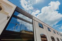 Kaboompics - Modern White Office Building with Reflective Glass Facade and Lisbon Sky