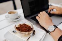 Kaboompics - Man Working on a Laptop with a Watch and Tiramisu