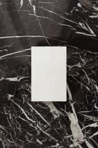 Kaboompics - Vertical Blank Business Card Mockup Centered on Black Marble with Generous Copy Space