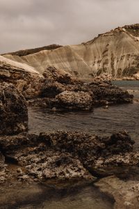 Kaboompics - Rocky Foreground Below a Pale Eroded Cliff