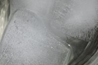 Kaboompics - Macro Close-Up of Ice Cubes in Clear Water with Glass Reflections, Abstract Summer Beverage Texture