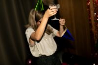 Kaboompics - Woman Raising a Champagne Glass with Colorful Party Accessories