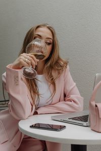 Kaboompics - Woman Drinking Wine at a Table with a Laptop