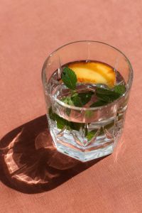 Kaboompics - Peach-Infused Drink Beside Strawberry Pasta Plate