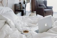 Kaboompics - Macbook, an iPhone, a coffee, a chocolate and a notebook in a bed