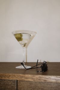 Kaboompics - Overhead Martini Cocktail with Green Olives and Sunglasses