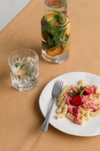 Kaboompics - Peach Water Carafe and Strawberry Pasta Table Setting