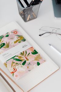 Kaboompics - Laptop, Brown Notebook and Illustrated Planner with Glasses