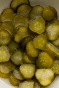 Kaboompics - Sliced Pickles Soaking in Brine in a Moody Close-Up