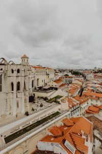 Kaboompics - Vertical View of Lisbon Rooftops beside a Weathered Gothic Church Ruin