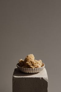 Kaboompics - Bowl of Natural Sea Sponges on a Concrete Block