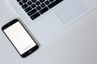 Kaboompics - White laptop with smartphone