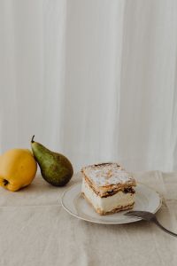 Kaboompics - Vertical Napoleonka Slice with Pear, Lemon and Negative Space