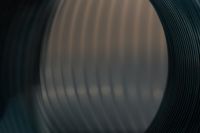 Kaboompics - Blurred Silver Coil Shape on a Dark Background