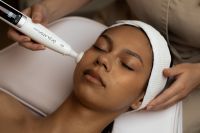Kaboompics - Handheld Facial Device Used on Woman's Cheek