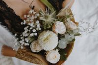 Kaboompics - White and Blush Bouquet Held Against Black Lace Lingerie
