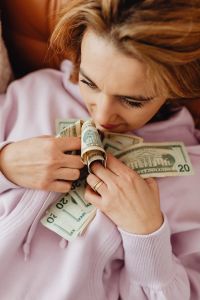 Kaboompics - Woman counts money - dollars - currency - bill