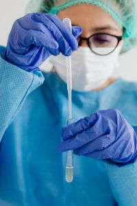 Kaboompics - Science Teacher Holding Pipette for Classroom Experiment