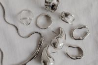Kaboompics - Assorted Silver Rings and Jewelry on White Fabric
