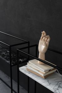 Kaboompics - Sculptural Wooden Hand, Stacked Books and Dried Branches on Marble Console