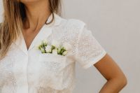 Kaboompics - Woman in White Eyelet Blouse with Small White Flowers in Pocket